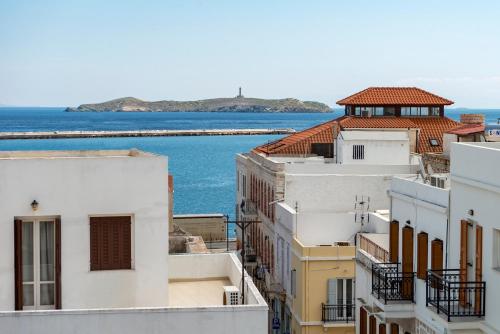 a view of the ocean from the roofs of buildings at Island of Luxury Apartments in Ermoupoli