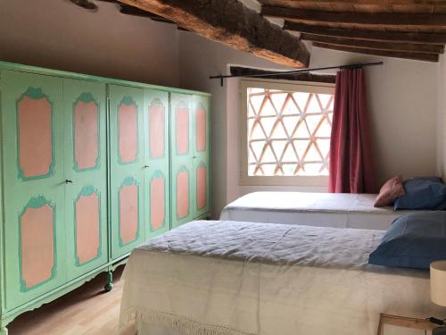 um quarto com 2 camas e um armário verde em Il Capriolo em Lucca