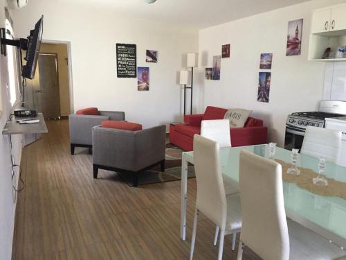 a living room with a table and some chairs at Zona Dorada Mazatlan in Mazatlán