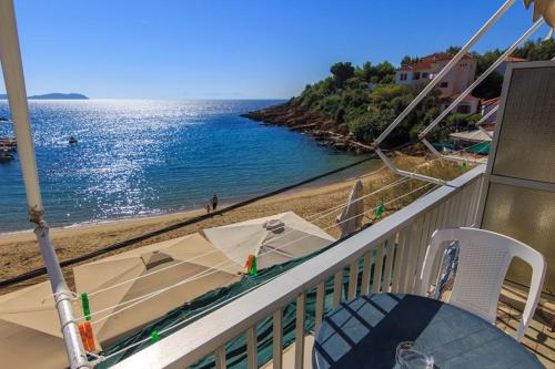 a balcony with a view of the beach and the ocean at VOULGARIS in Agios Georgios