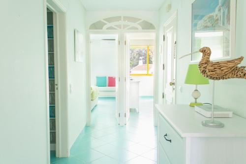 a kitchen with a table with a duck lamp on a counter at Quinta Do Romao, Vilamoura in Quarteira