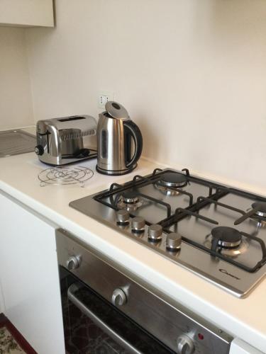 a stove top with a tea kettle on top of it at La Suite del Centro in Lazise
