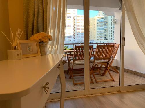 a room with two chairs and a table with a window at Laukamao Praia Da Rocha in Portimão