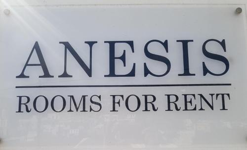 a sign with the words raises rooms for rent at Anesis in Diafani