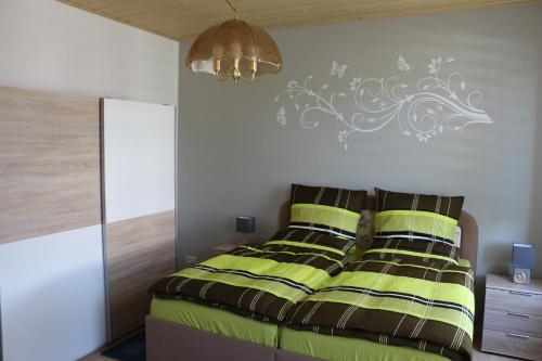 a bedroom with a bed with green and brown sheets at Susanne in Koblenz
