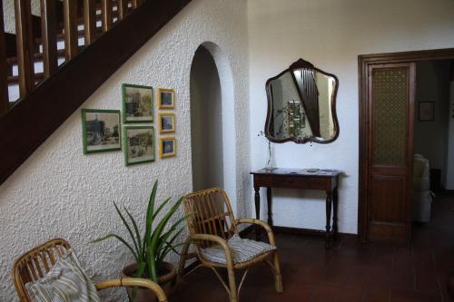 a hallway with a chair and a mirror and a table at Dimora Sabatini B&B in Oriolo Romano