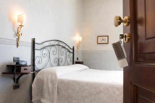 a bedroom with two beds with white sheets at Sunrise Guest House in Maiori