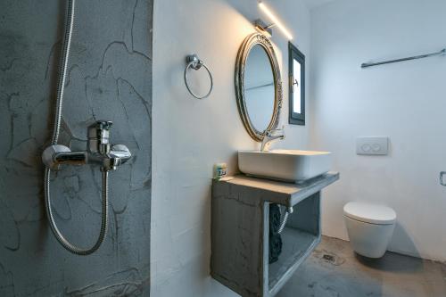 a bathroom with a sink and a mirror at Sun Springs Suites in Kamari