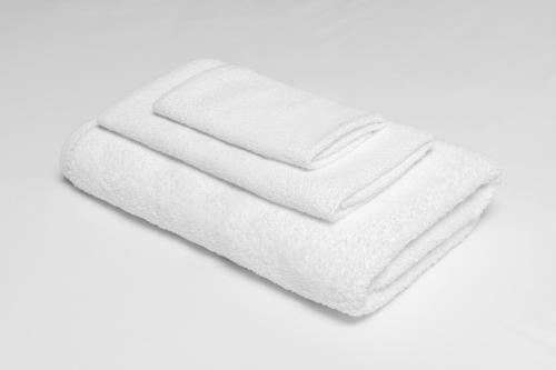 a stack of white towels on a white background at Americas Best Value Inn and Suites - Nevada in Nevada
