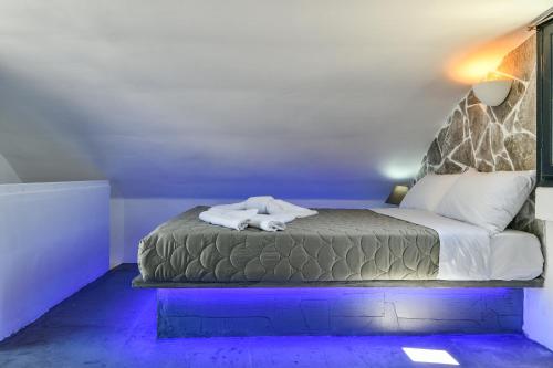 a bed with two white towels on top of it at Sun Springs Suites in Kamari