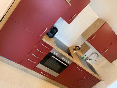 an overhead view of a kitchen with red cabinets at Comfort Lodging Stueckenfeld in Hannover