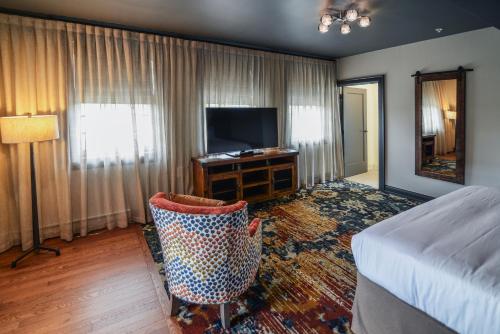 a hotel room with a bed and a television at The Stella Hotel & Ballroom in Kenosha