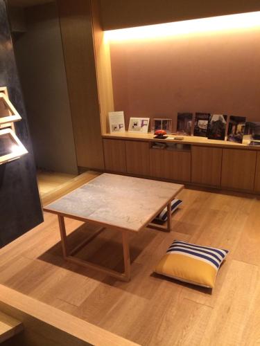 - une table en bois dans une pièce avec un comptoir dans l'établissement WOW-GINZA, à Tokyo