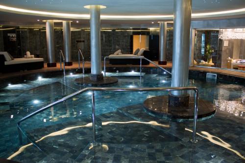 a large swimming pool in a hotel lobby at Sofitel Montevideo Casino Carrasco & Spa in Montevideo