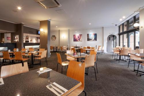 a dining room with tables and chairs in a restaurant at Black Buffalo in Hobart
