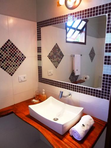 a bathroom with a white sink and a mirror at Pousada Halai in Morro de São Paulo