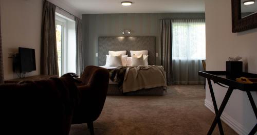 a hotel room with a bed and a television at Queenstown Country Lodge in Queenstown