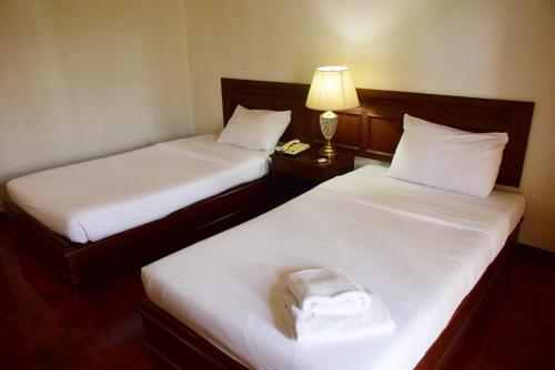 Katil atau katil-katil dalam bilik di Puangpen Villa Hotel