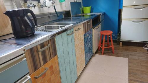 a kitchen counter with a sink and a stove at GUEST HOUSE SaKURa in Tokyo