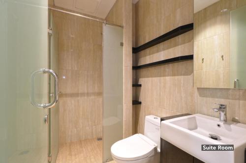 a bathroom with a sink and a toilet and a shower at Plaza 54 Residence in Jakarta