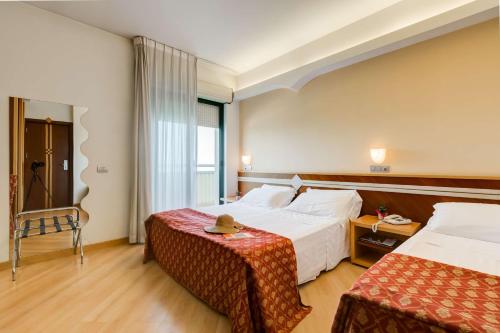 מיטה או מיטות בחדר ב-Hotel Europa Beach Village