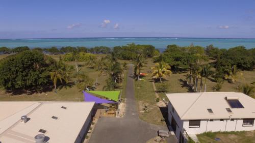 an aerial view of a house and the ocean at Auberge de Poé in Bourail
