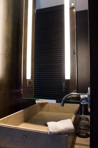 a bathroom with a tub with a mirror and a sink at Sofitel Montevideo Casino Carrasco & Spa in Montevideo