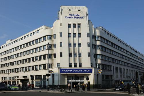 a large white building with a sign on it at Best Western Buckingham Palace Rd in London