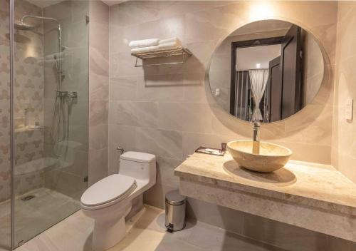 a bathroom with a sink and a toilet and a shower at Len's Hotel in Da Lat