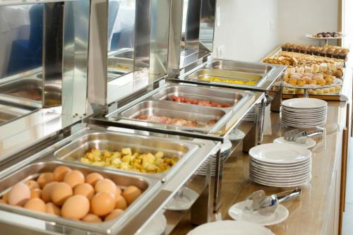 a buffet line with eggs and other food items at Hotel O Sole Mio in SantʼAgata sui Due Golfi