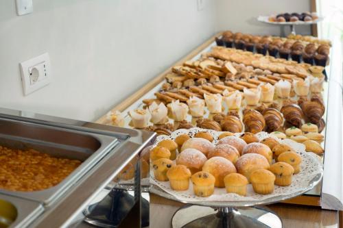 a bunch of donuts and other pastries on display at Hotel O Sole Mio in SantʼAgata sui Due Golfi
