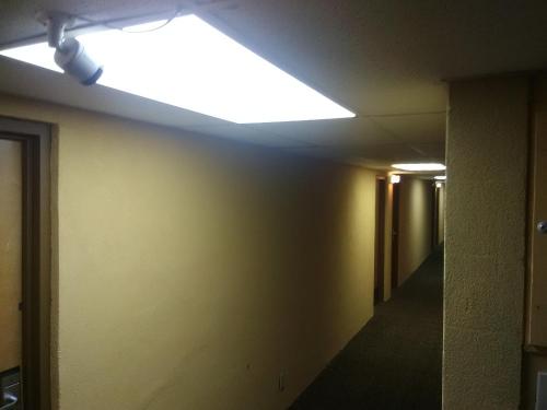 an empty hallway with a light on the ceiling at Travelodge by Wyndham Bloomington in Bloomington
