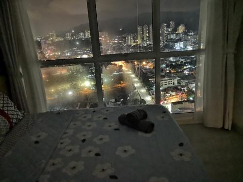 a room with a view of a city from a window at Strait Garden Suites X Ace Pro @ George Town in Jelutong