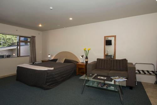 a living room with a bed and a couch at Lake Point Motel in Hamilton