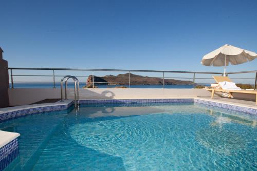 a swimming pool with a view of the ocean at Sandy Point Villas Chania in Agia Marina Nea Kydonias