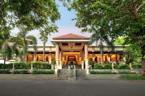a building with a staircase in front of it at Bali Relaxing Resort and Spa in Nusa Dua