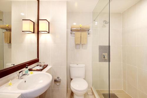 a bathroom with a toilet and a sink and a shower at Bali Relaxing Resort and Spa in Nusa Dua