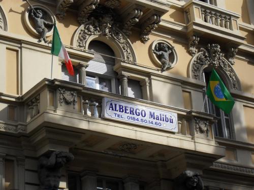 a sign on the side of a building with two flags at Albergo Malibu in Sanremo