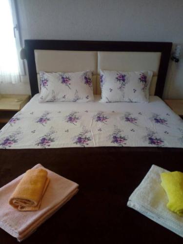 a bed with two pillows and a plate on it at Villa Beba in Dobra Voda