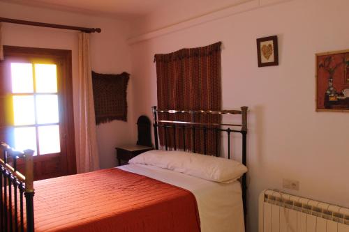 a bedroom with a bed and a window at Casa Nieves in Ronda