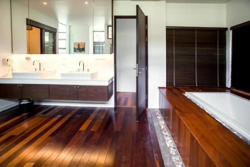 a bathroom with two sinks and a large mirror at Amatapura Beach Villa 6 in Ao Nam Mao