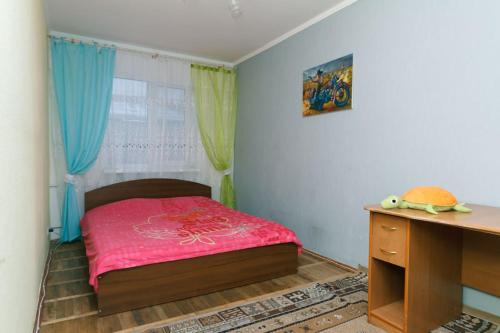 a small bedroom with a bed and a desk at Донца 18, Шалимова, НАУ, 2-х комнатная Отрадный проспект, спорткомплекс Венето, Миридиан, ИСИДА, ISIDA, Шулявская 15 мин in Kyiv