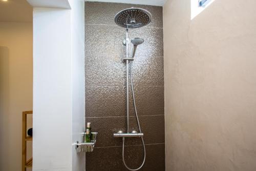 a shower with a shower head in a bathroom at La Vista Luxury Apartment Jan Thiel in Jan Thiel
