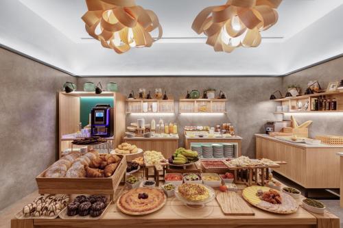 a bakery with many different types of food on a table at Protur Naisa Palma Hotel in Palma de Mallorca