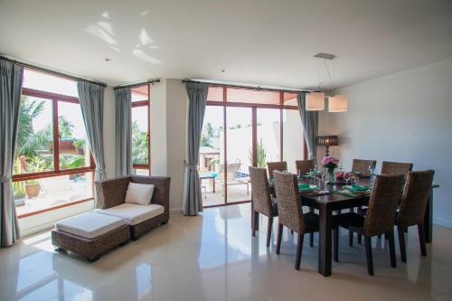 a dining room with a table and chairs at Amatapura Villa 26 in Ao Nam Mao