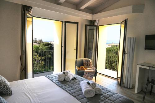 a bedroom with a bed with towels and a chair at La Torre del Mulino - SUPERIOR Rooms in Tropea