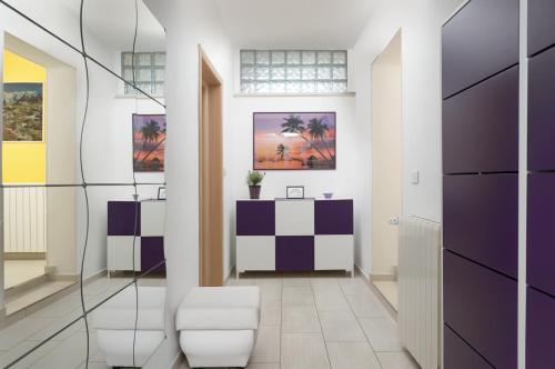 a hallway with purple and white walls and a desk at RAINBOW in Pula