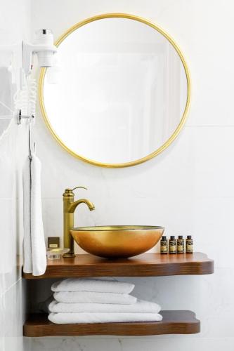 a bathroom with a bowl sink and a mirror at A for Art Hotel in Limenas