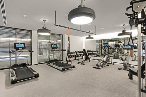 a gym with several treadmills and machines in it at Protur Naisa Palma Hotel in Palma de Mallorca