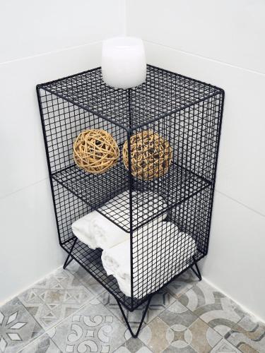 a black wire shelf with two donuts on it at Studio Ariana and patio in Bat Yam